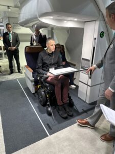 a man in a wheelchair with a tray in his hand
