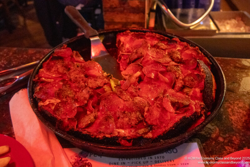 a pizza with a spatula in a pan