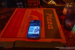 a cell phone on a pizza box