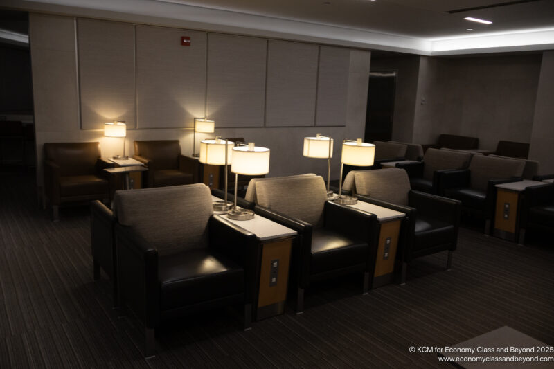 a group of chairs with lamps in a room