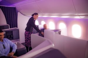 a woman standing next to a man in an airplane