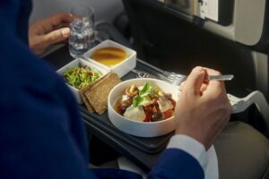 a person eating food on a tray