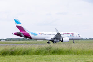 a white airplane on a runway