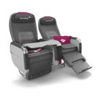a grey and pink recliner chair with a pink pillow