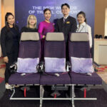 a group of people standing next to a row of chairs