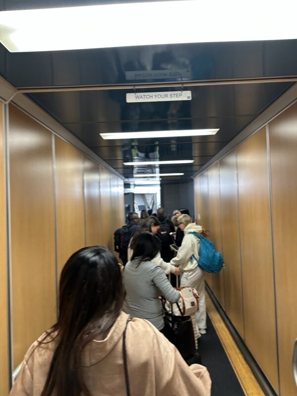 a group of people walking down a hallway