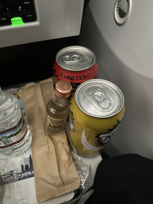 a group of soda cans and a bottle of liquid