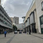 a street with buildings and people walking