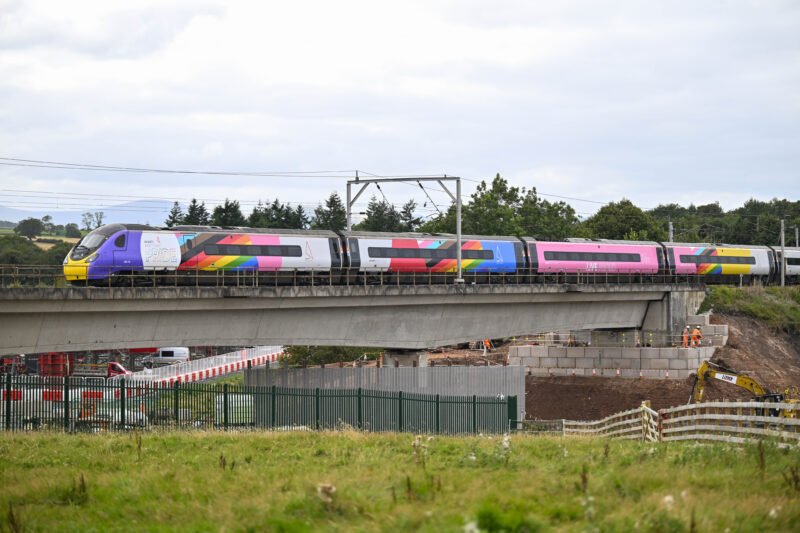An Avanti West Coast train runs along west coast main railway line in Cumbria and crosses the bridge over the M6 Motorway at Clifton near Penrith. Work is taking place to replace the bridge with a new bridge set to be installed early in 2026: 20 August 2025 STUART WALKER/AVANTI WEST COAST