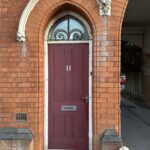 a red door in a brick building