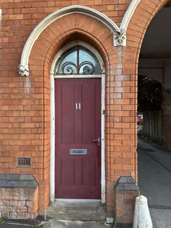 a red door in a brick building