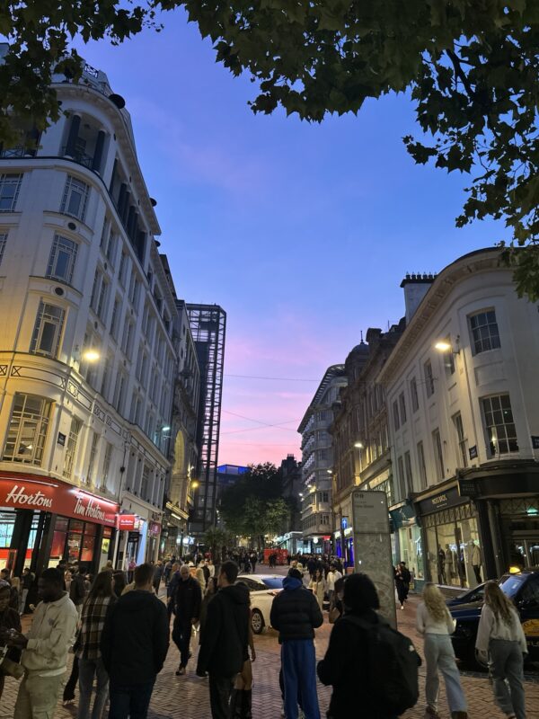 New Street at dusk with the party crowd out. Birmingham