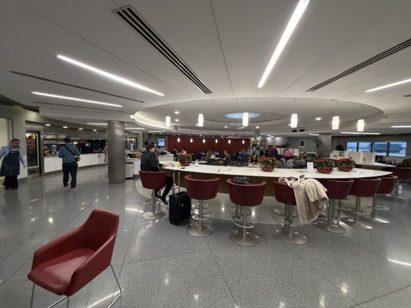 a group of people sitting at a table in a room with chairs