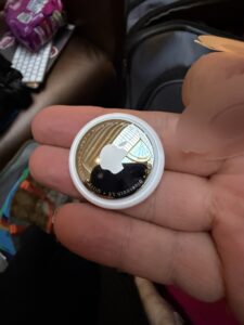 a hand holding a silver coin