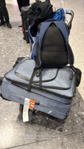 a backpack on top of luggage