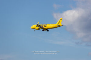 a yellow airplane in the sky