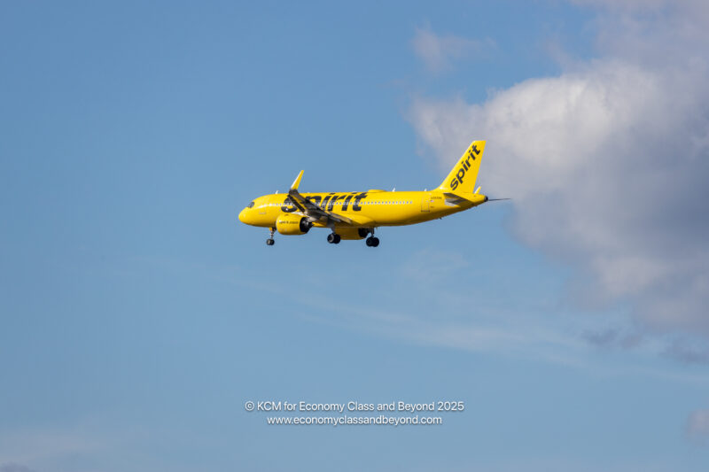 a yellow airplane in the sky