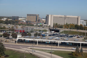 a parking lot with cars and buildings in the background