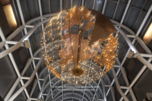 a large globe with lights from the ceiling