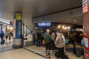 a group of people standing in a line in a building