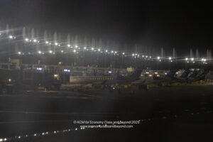 an airport at night with lights and airplanes
