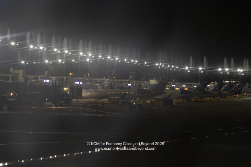 an airport at night with lights and airplanes
