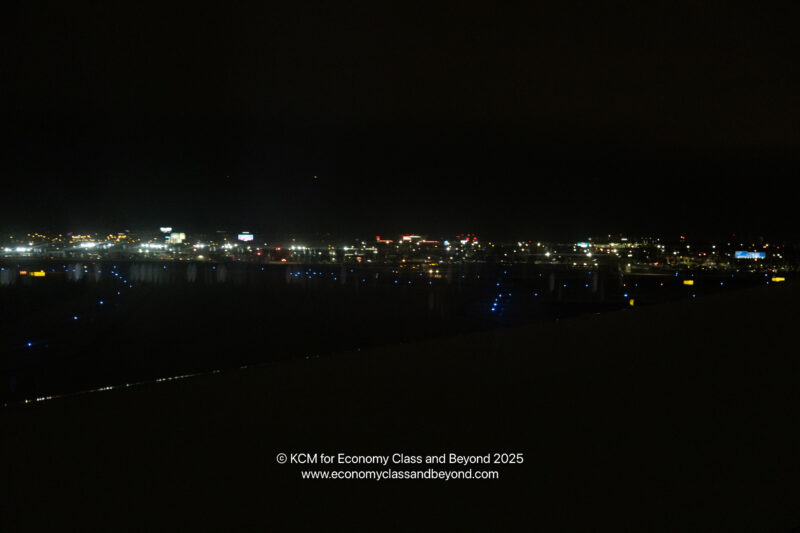 a city at night with lights on the water