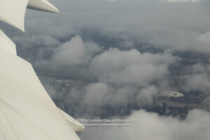 a view of clouds and city from an airplane