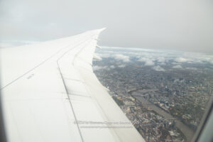 an airplane wing and city view