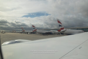 a group of airplanes parked at an airport
