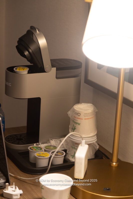 a coffee machine with cups and a lamp