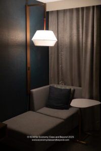 a chair with a lamp and a table