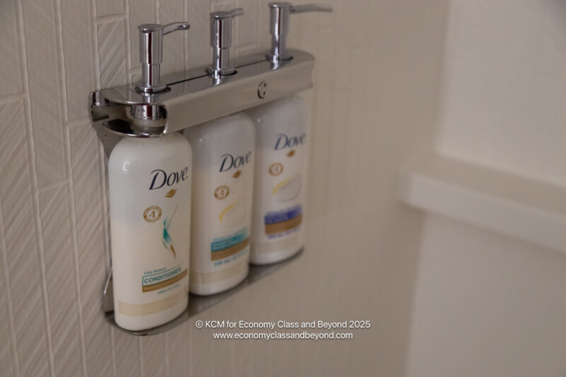 a group of shampoo bottles on a metal holder