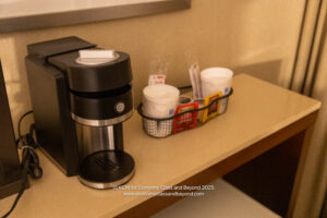 a coffee maker and coffee cups on a table