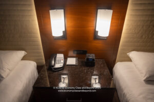a phone on a table next to two beds