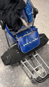 a blue bag on a luggage cart