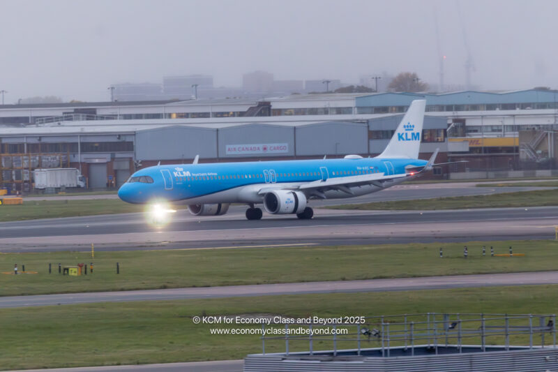 a blue airplane on a runway
