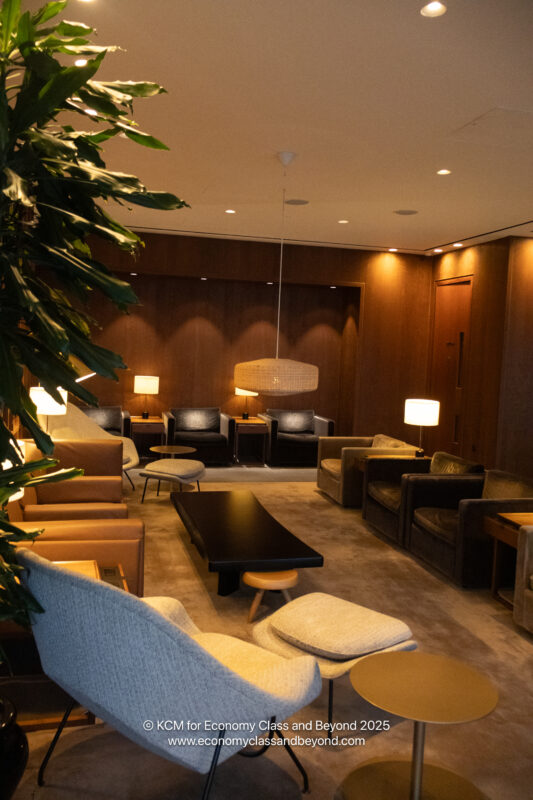 a room with a couch and chairs