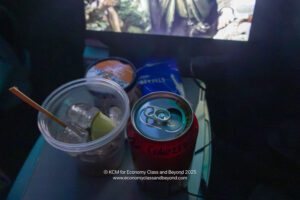 a soda can and a drink in a plastic cup