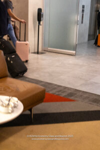 a group of people with luggage in a lobby