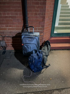 a suitcases and a backpack outside a building