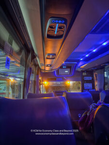 inside a bus with seats and lights