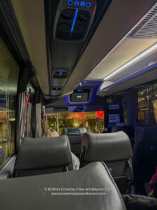 inside a bus with seats and lights