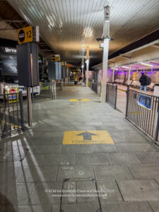 a walkway with signs and benches