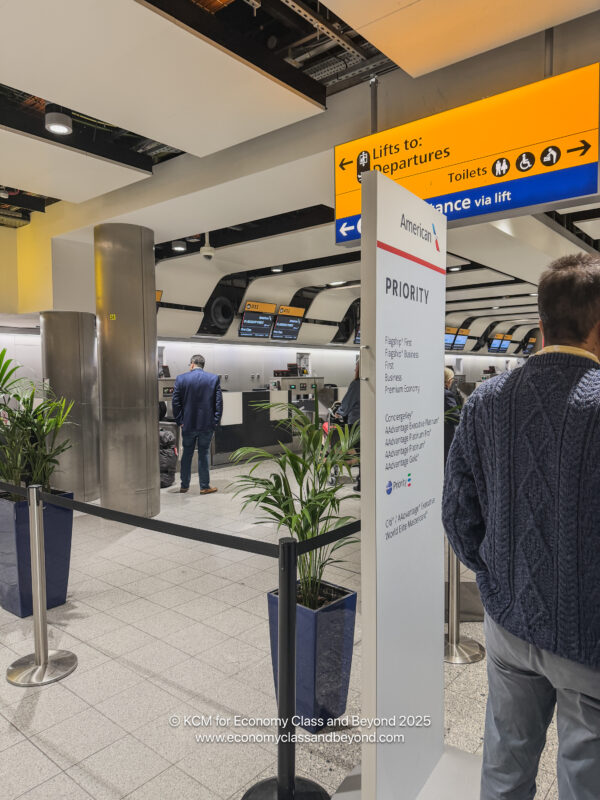 people standing in a line at an airport