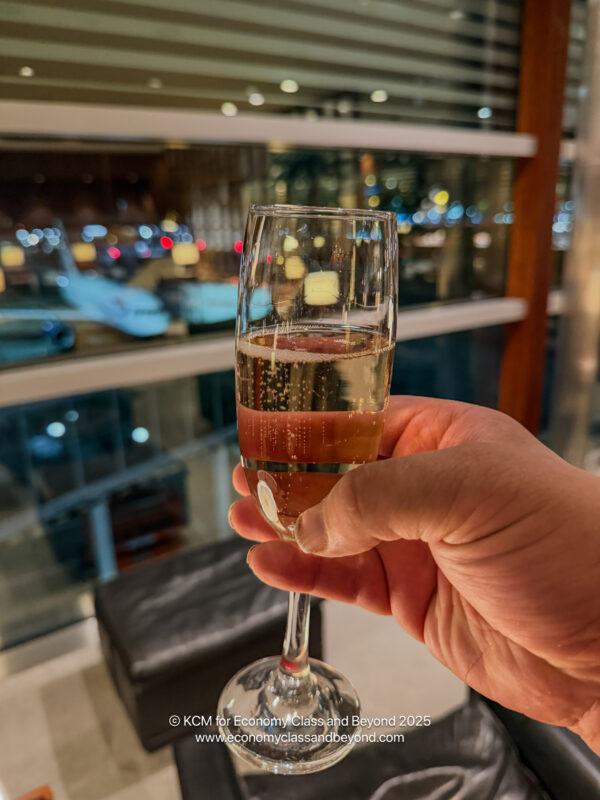 a hand holding a glass of champagne