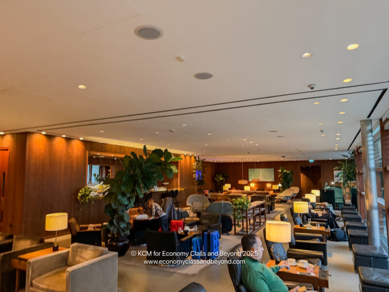 a room with chairs and tables and lamps