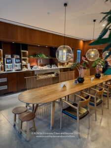 a long table with chairs and a large plant in front of it