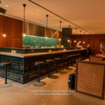 a bar with a counter and chairs