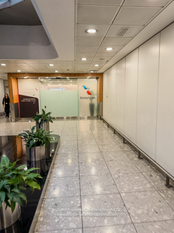 a hallway with plants and a sign